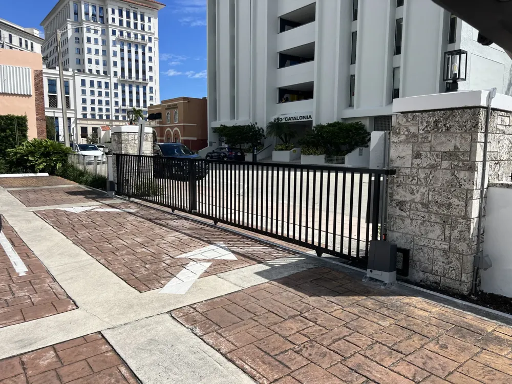 Automated commercial sliding gate installed at a Miami building entrance