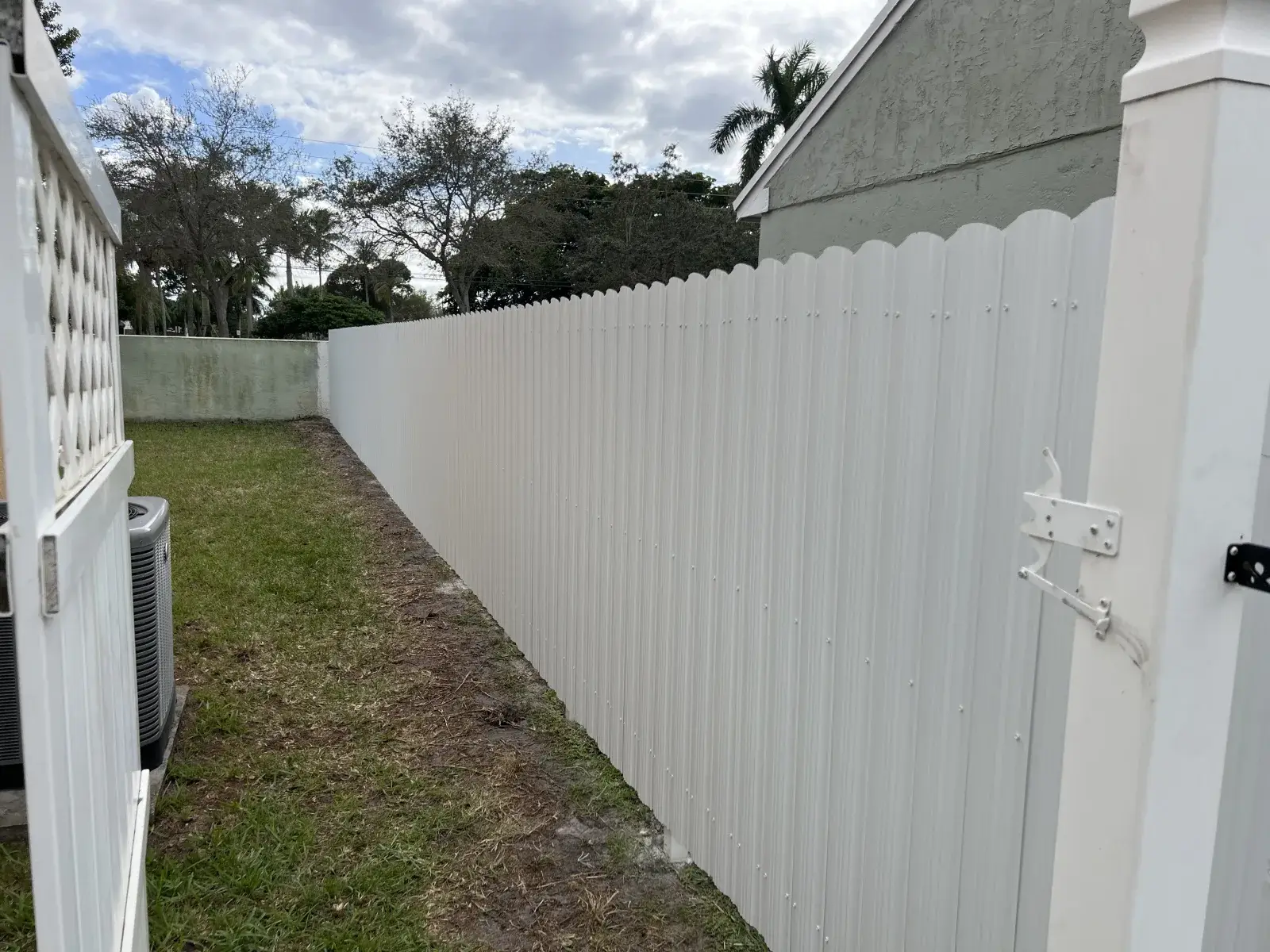 White Dura Fence metal privacy fence installed in a Miami backyard