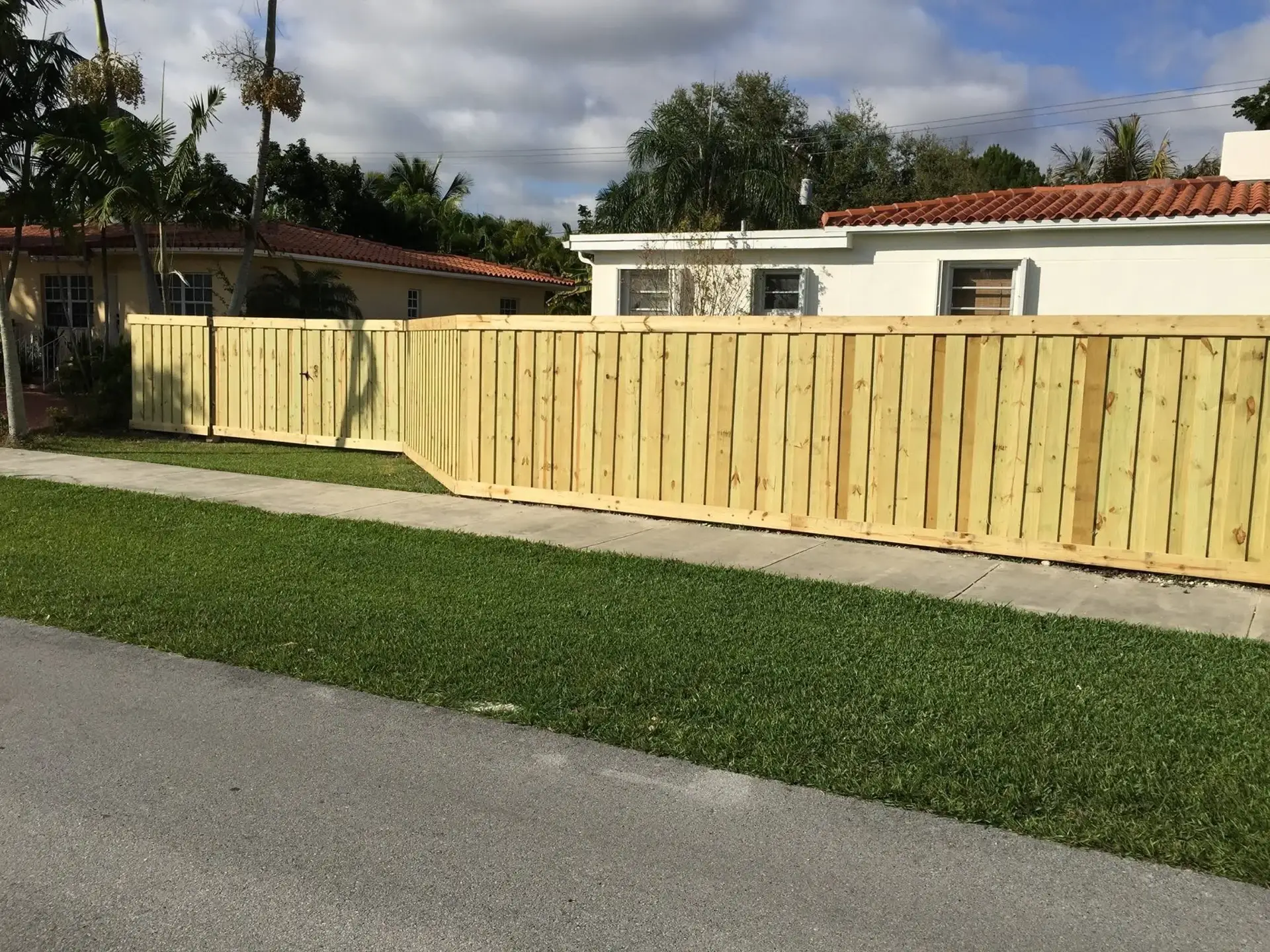Horizontal wood privacy fence installed along a Miami property line