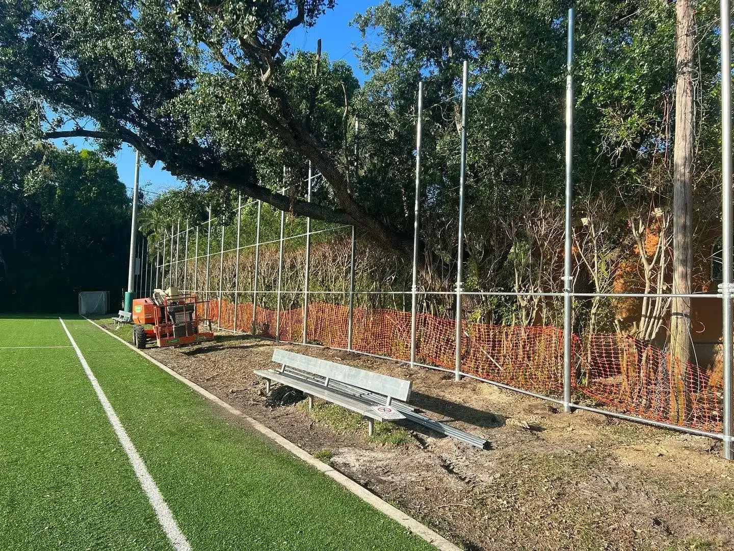 Split rail fence along a wooded Miami-Dade property
