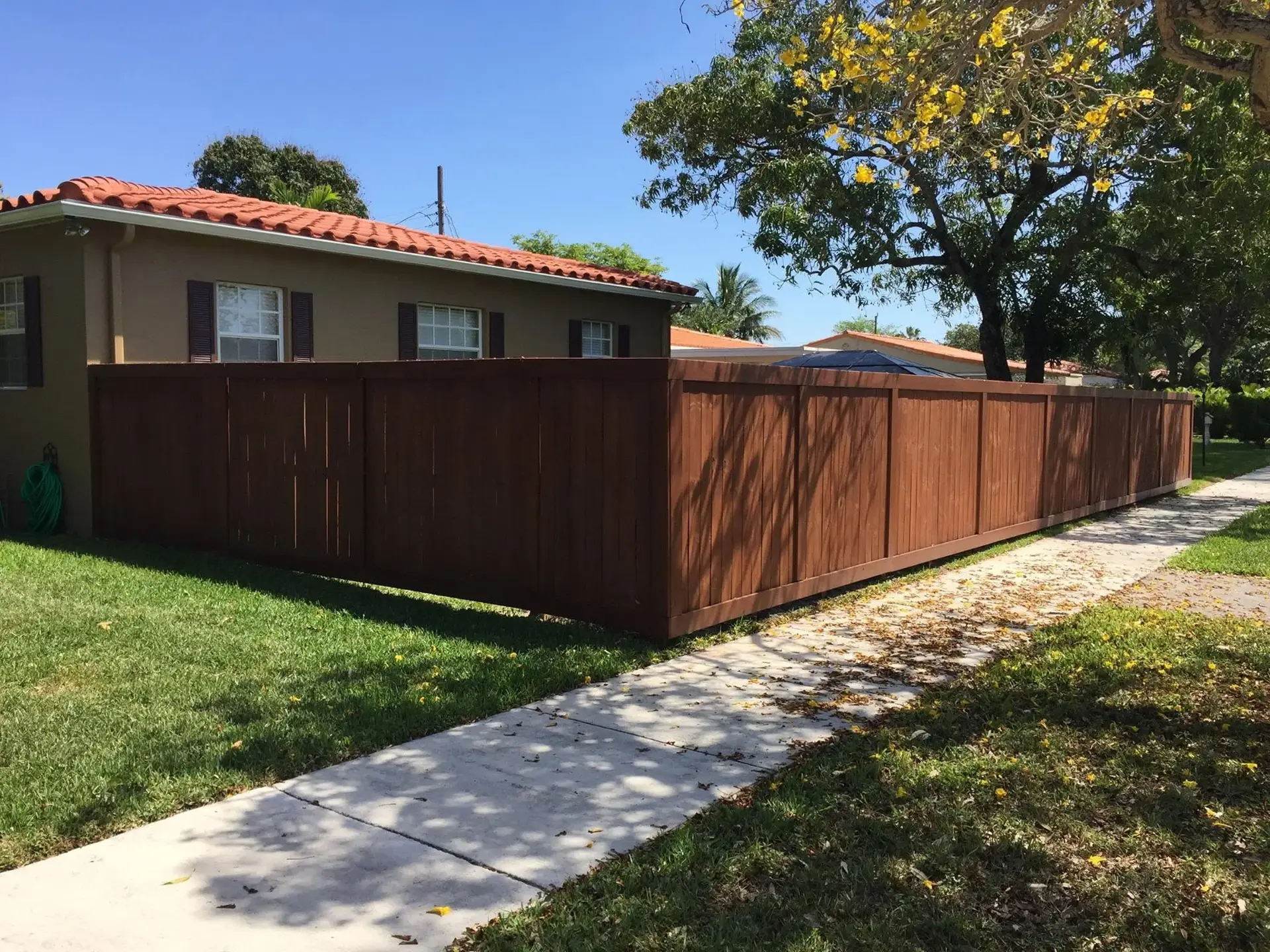 Stained wood privacy fence installed in Miami, FL